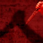 knife against the wall with red tint over the image